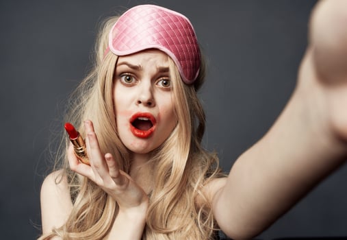 sexy blonde woman with red lipstick emotions and pink mask on her face photo
