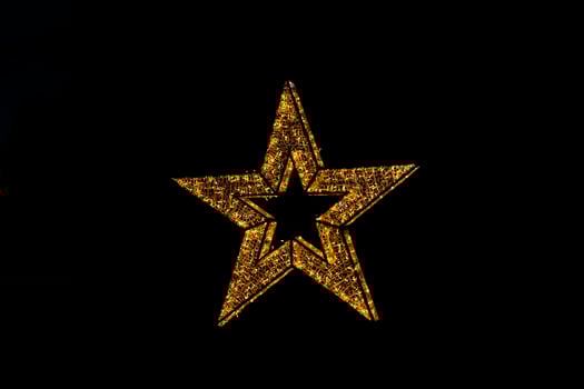 golden decoration shining star christmas decoration on black background photo