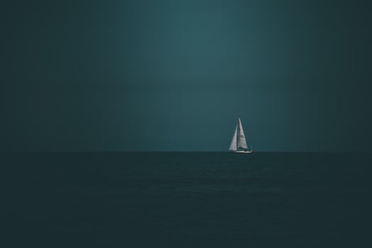 summer landscape from the Baltic Sea with blue water and sky and a white sailboat photo