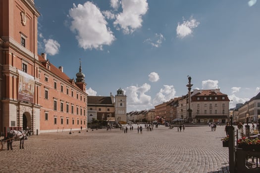 landscape from the square of the old town of Warsaw in Poland with the royal castle and tenement houses photo