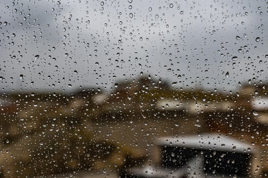 background glass pane in drops of water with a view of the spanish stone photo