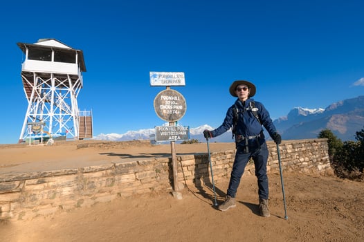 A young traveller trekking in Poon Hill view point in Ghorepani, Nepal photo