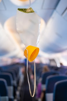 oxygen mask drop from the ceiling compartment on airplane photo
