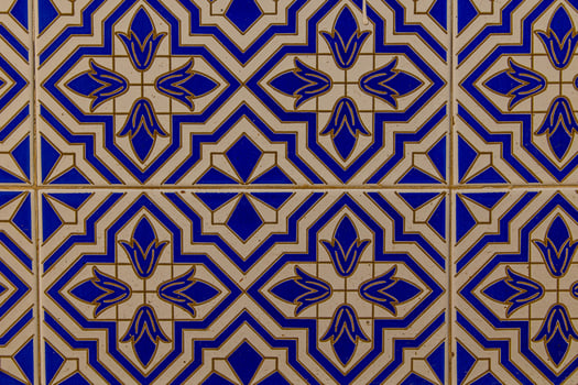 background of white-blue ceramic tiles with classic spanish patterns photo