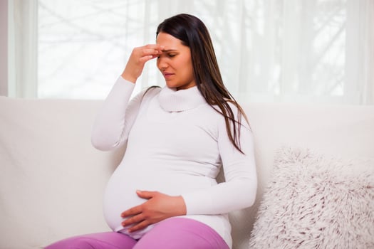 A pregnant woman with discomfort photo