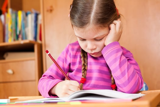 Little girl doing homework photo