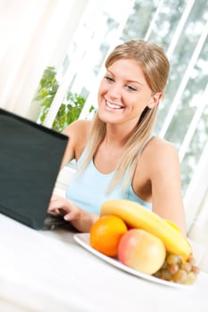 Young blonde woman with fruit for health and wellness concept photo