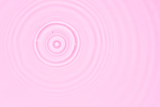 Water surface abstract background texture with splashes and bubbles. Pink color photo