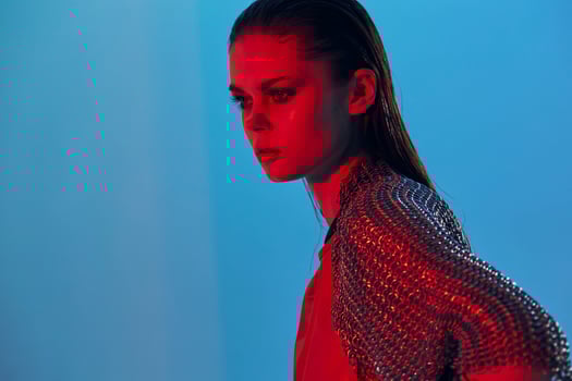 beautiful woman red light silver armor chain mail fashion isolated background photo