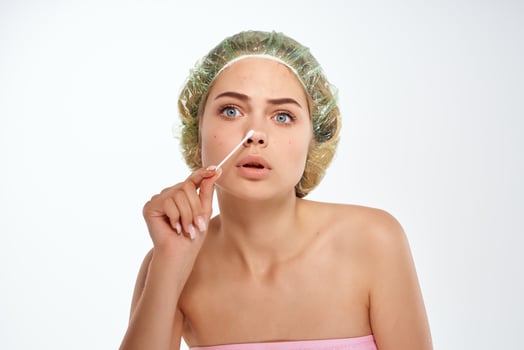 emotional woman with bare shoulders hygiene pimples on her face photo