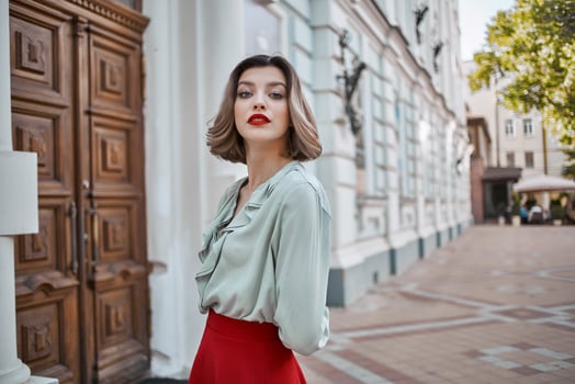 cheerful woman outdoors on the street walk near the building photo