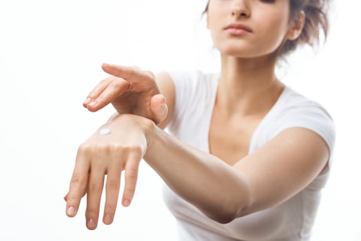 woman with cream skin care cosmetics health light background photo