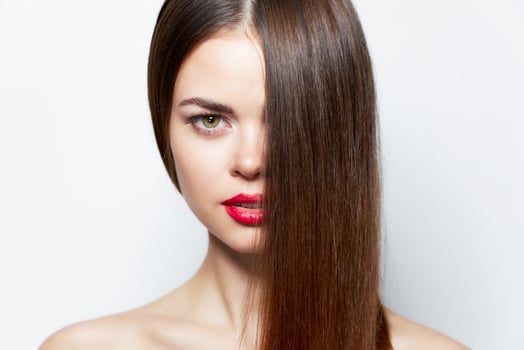 Attractive woman Red lips long hair cover the face with a cropped look clear skin photo