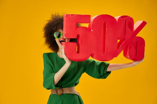 Portrait of a charming lady curly hairstyles green dress fifty percent discount yellow background unaltered photo