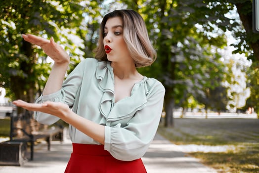 pretty woman in red skirt walking in the park trees fresh air posing photo