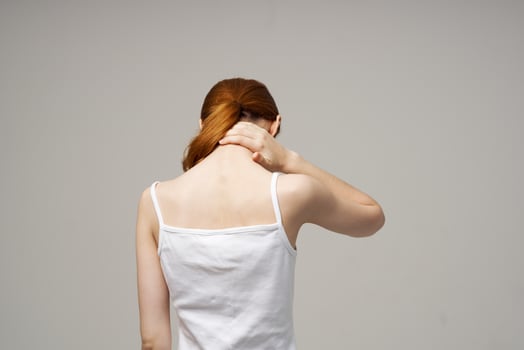 disgruntled woman pain in the neck arthritis chronic disease studio treatment photo