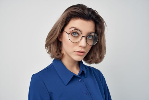 woman blue shirts with glasses fashion posing light background photo