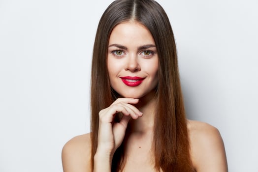 Sexy woman Beautiful smile hand near the chin bright makeup photo