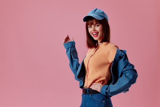Portrait of a charming lady denim cap red lips glamor fashion color background unaltered photo