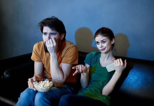evening tv watching and a married couple with popcorn in a plate photo