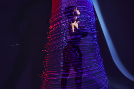 Positive young woman neon lines light posing color background unaltered photo