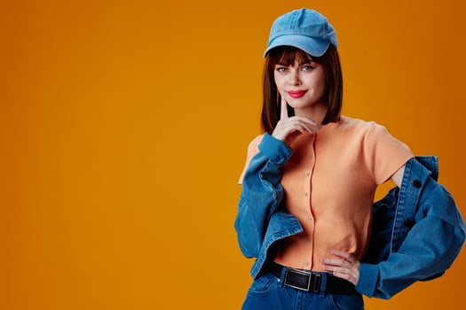 Positive young woman denim cap red lips glamor fashion color background unaltered photo