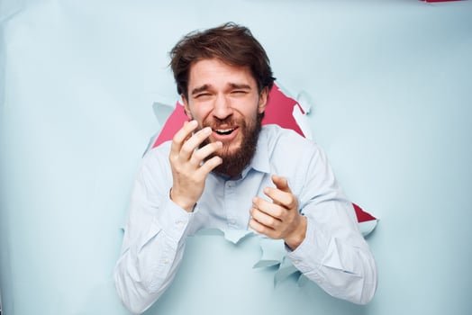 man in manager shirt peeks out of the wall emotions photo