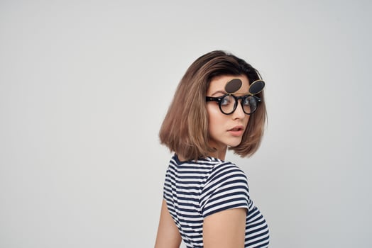 woman in striped t-shirt sunglasses studio isolated background photo