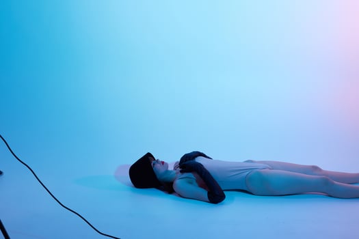 woman in black hat lies on the floor isolated background photo
