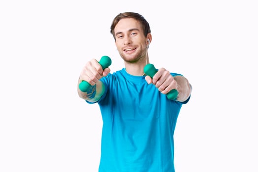 man in blue t-shirt holding dumbbells fitness exercise photo