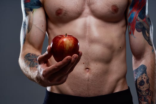 nude bodybuilder with pumped muscles and tattoo apple in hand health photo