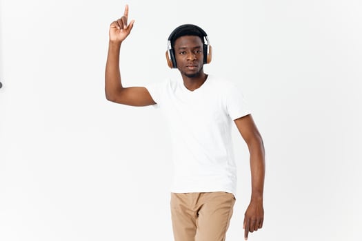 man in headphones gesturing with hands music technology fun isolated background photo