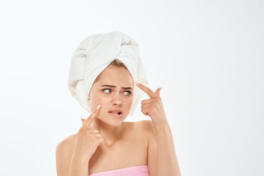 unhappy woman with bare shoulders skin problems dermatology photo