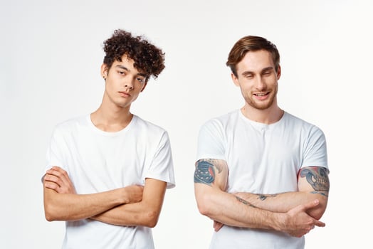 funny two men in white t-shirts are standing side by side isolated background photo