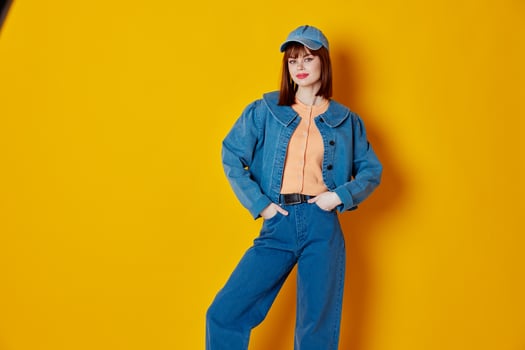 Portrait of a charming lady stylish denim clothing posing yellow background unaltered photo
