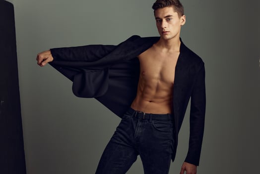 Handsome man unbuttoned jacket attractive look fashionable hairstyle studio modern style photo