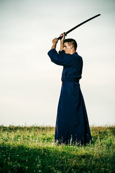 Silhouette of kendo fighter with shinai photo