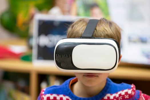 Child in virtual glasses. The boy in 3D glasses. photo
