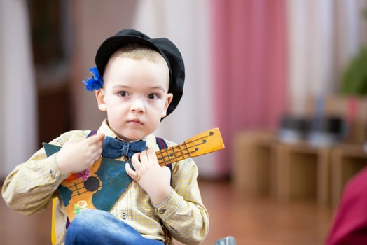 Russian boy with a balalaika. Funny preschooler with Russian folk musical instrument. photo