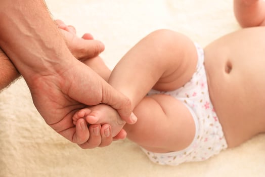 masseur doing massage for foot little baby photo