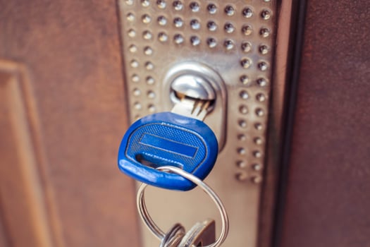 The key in the lock of the iron door. Toned image. photo