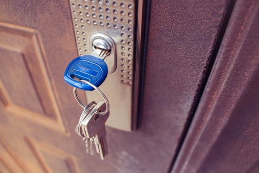 The key in the lock of the iron door. Toned image. photo