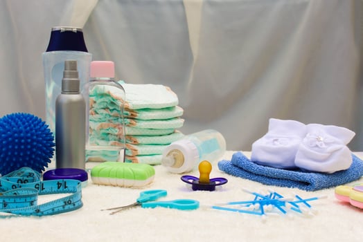 Baby accessories pacifier, bottle, disposable diapers, scissors, funds for the bath, the ball for massage, meter to measure the growth of the child, comb, oil for body photo