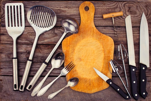 kitchen utensils on wooden background. Toned image. photo