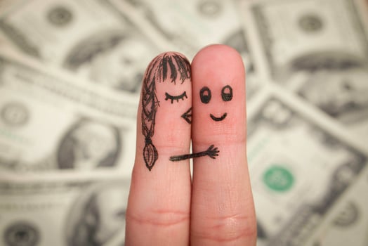 Girl kisses boy on the cheek on the background of money. photo