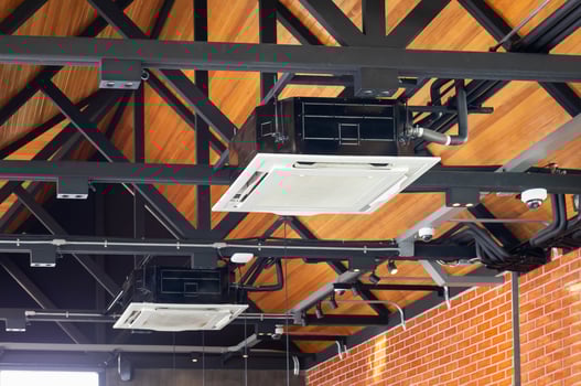 Modern ceiling mounted cassette type air conditioning system in coffee shop photo