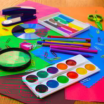 Stationery objects. School and office supplies on the background of colored paper. photo