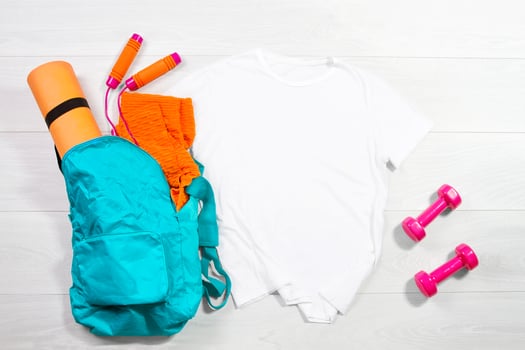 White female sport fitness t shirt mockup flat lay on wooden background. Summer pilates stratching saccessories. Sporty leggins, yoga mat. Top front view t-shirt.T-shirt Template blank copy space photo
