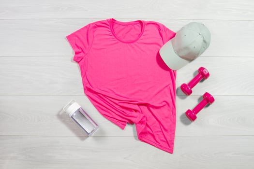 Pink female sport run fitness t shirt mockup flat lay. wooden background. Summer pilates stratching saccessories. Sporty water bottle, dumbbells, hat. Top front view t-shirt. Template blank copy space photo