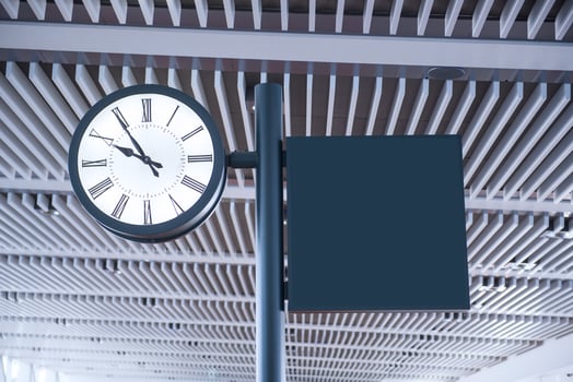 Clock at an international airport and sign photo